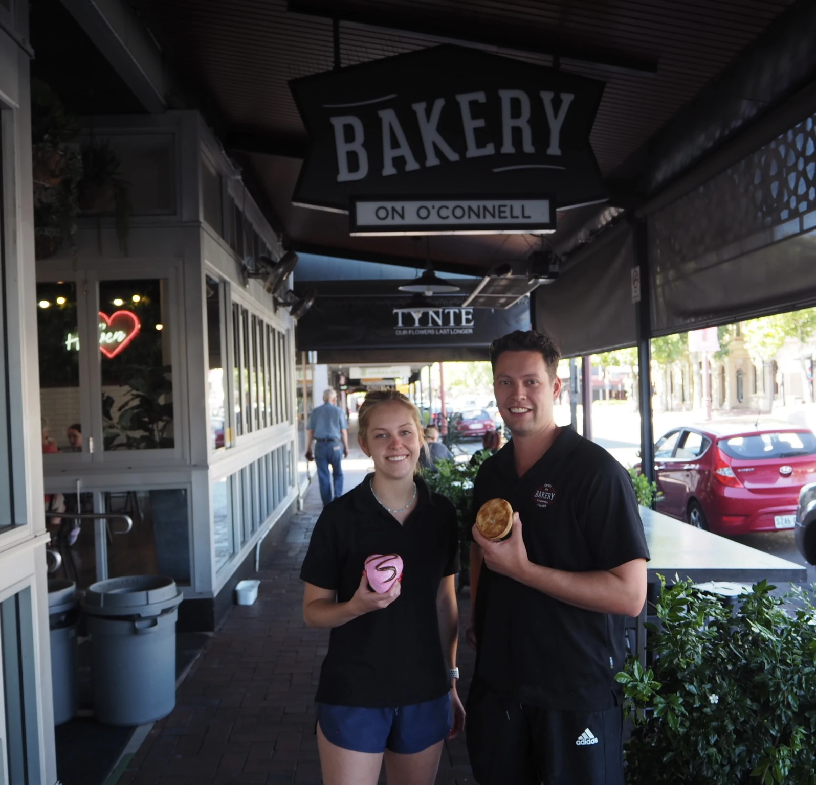 Two of the team outside the bakery, under the verandah.