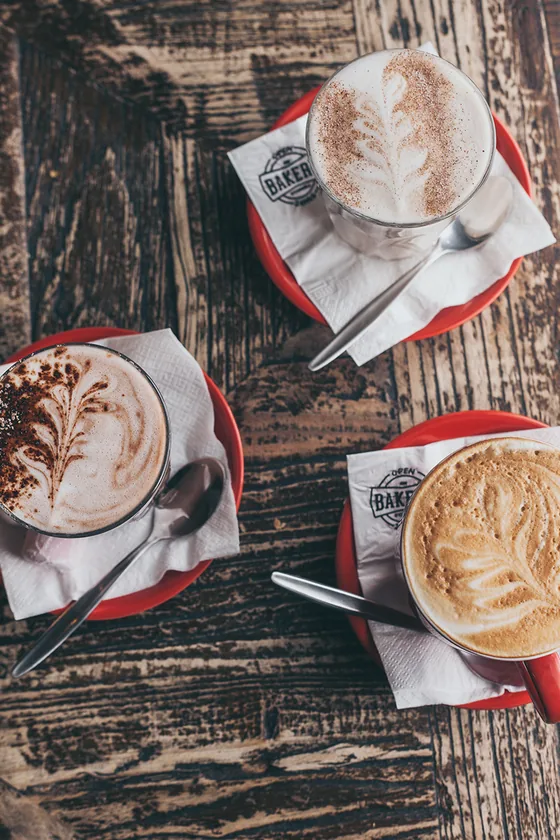 Two coffees with latte art on Bakery on O’Connell napkins.