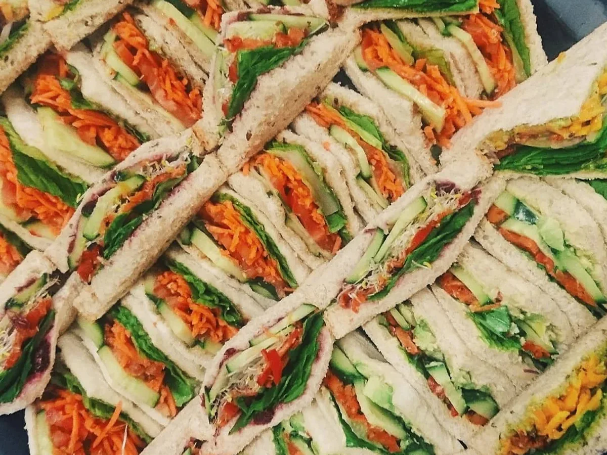A platter of sandwiches cut into quarters.