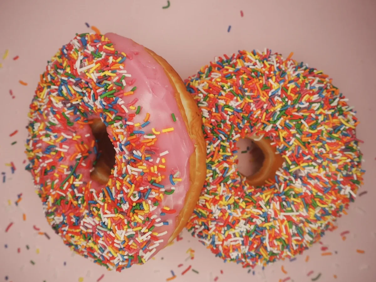 Two donuts thick with hundreds and thousands.