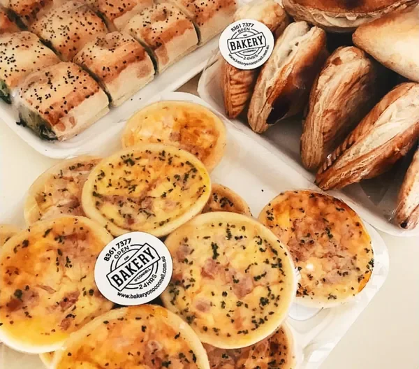 A platter of mini quiches, sausage rolls and pastries.