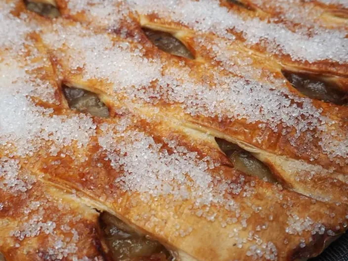 A sugar dusted lattice topped fruit pie.